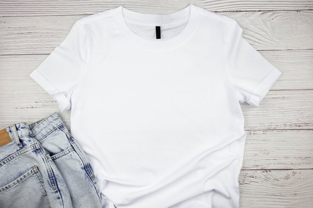 White Womens Cotton Tshirt Mockup with Blue Jeans Pants on Wooden Background. Design T Shirt Template, Print Presentation Mock up. Top View Flat Lay.